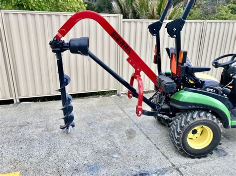 small tractor digger|tractor with post hole digger.